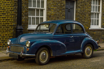 Old blue car parked on the street, old london, old building in london