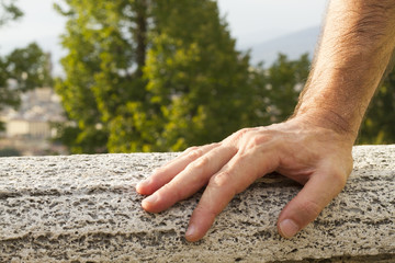 Mano uomo appoggiata su un muro