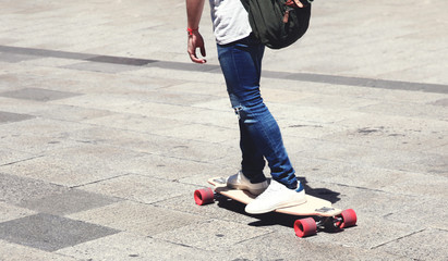 Man on a skateboard longboard closeup in the city © guas