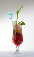 Glass of red ice tea with mint and lemon isolated