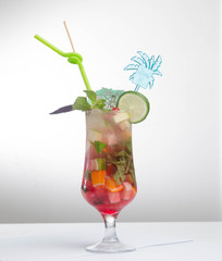 Glass of red ice tea with mint and lemon isolated
