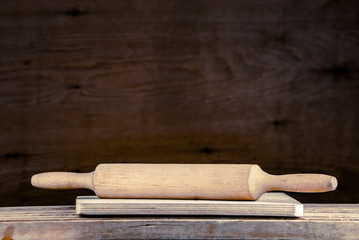 Rural kitchen scene. Rolling-pin on wood.