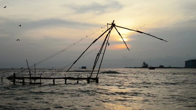 Kerala, India. Chinese fishnets in Cochin, Kerala, India at sunset. Boat at the background