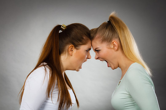 Two agressive women having argue fight
