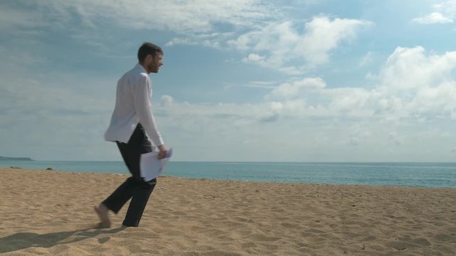 Clerk with documents and office papers falls from fatigue on the beach. An employee can no longer work in the business sphere.