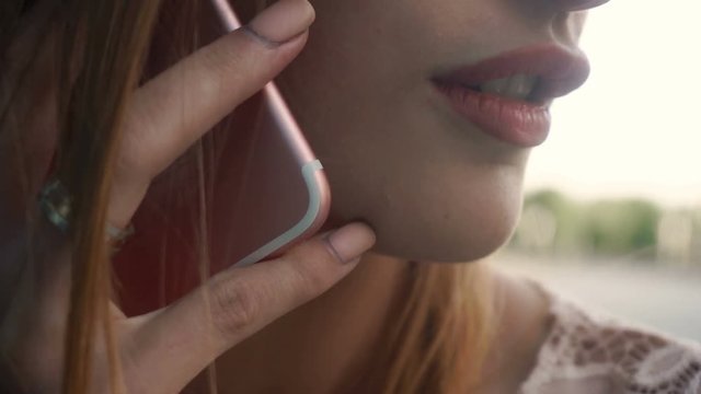 close up of young woman with red lips talking phone