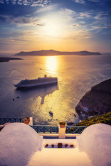 Amazing evening view of Fira, caldera, volcano of Santorini, Greece with cruise ships at sunset. Cloudy dramatic sky. - obrazy, fototapety, plakaty