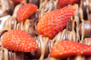 close up of strawberries on melt chocolate