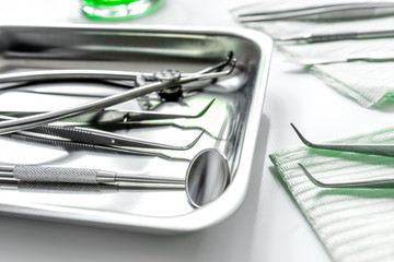 dentistry with dentist tools close up on white background