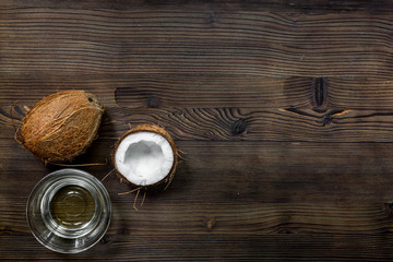 coconut water in glass to drink and fresh coconut on wooden background top view mock up