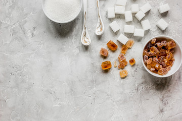 variety of sugar in bowls on gray table background top view space for text