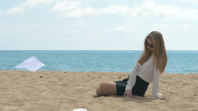 Pretty Gril From Office Takes Rest On The Beach. Business And Official Papers Flying By On The Seaside. An Employee Can No Longer Work In The Business Sphere.