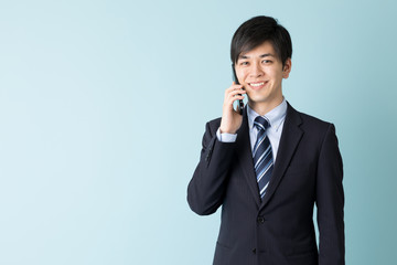 portrait of asian businessman isolated on blue background