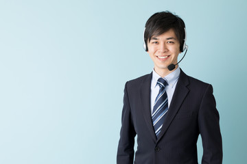 portrait of asian businessman isolated on blue background