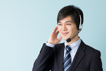 portrait of asian businessman isolated on blue background