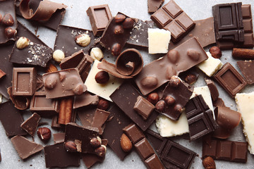 Heap of broken chocolate pieces on table
