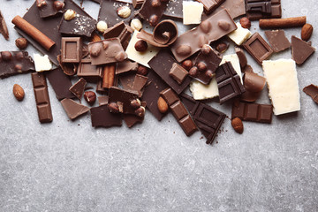 Heap of broken chocolate pieces on table