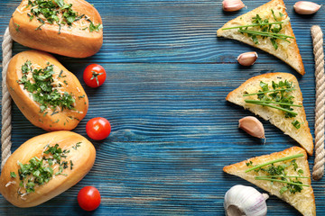 Tasty bread with grated cheese, garlic and herbs on cutting board