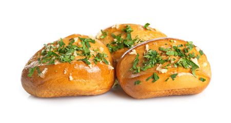 Tasty buns with grated cheese, garlic and herbs on white background