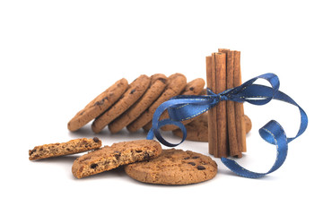 Oatmeal cookies with chocolate, cinnamon sticks on white background