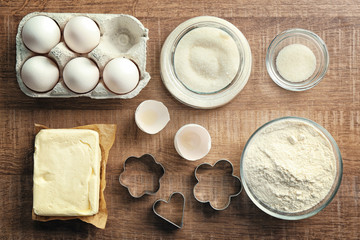 Fototapeta na wymiar Ingredients for preparing butter cookies on kitchen table