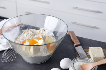 Ingredients for preparing butter cookies on kitchen table