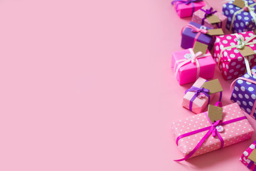 Colored gift boxes with colorful ribbons. Pink background. Gifts for St. Valentine's Day or a birthday.