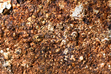 Severely corroded metal under the cracked and swollen enamel rusty
