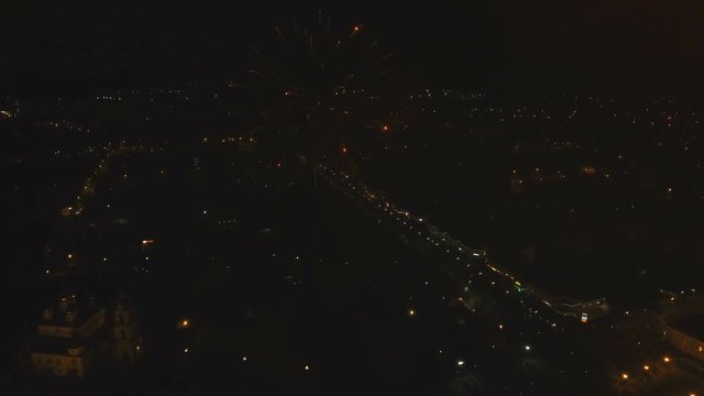 Aerial view Beautiful fireworks video from the drone in the night sky on celebration. Sparks. Fireworks are a class of explosive pyrotechnic devices used for aesthetic and entertainment purposes