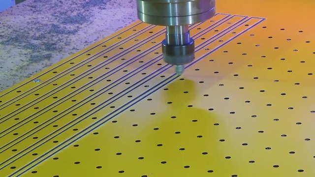 Milling cnc cuts the plastic panel hpl. The cnc spindle with the plastic cutter moves from bottom to top.
