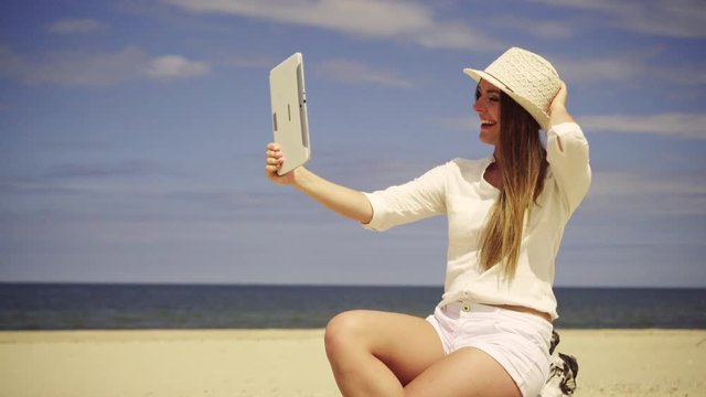 Beauty girl spending time on beach taking selfie photo with tablet. Positive young woman on seaside. Fun and joy. Summer time 4K ProRes HQ codec