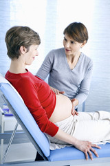 Doctor examining a pregnant woman's abdomen