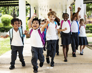 Group of diverse kindergarten students running cheerful after school