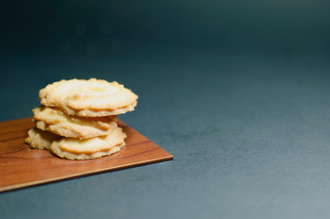 Cookies on wooden plate and blur background