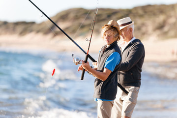 Senior man fishing with his grandson