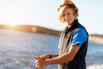 Teenage boy fishing at sea