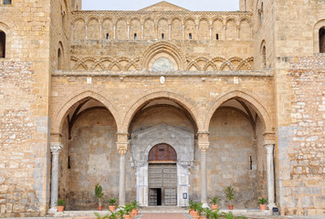 Fototapeta na wymiar The 15th-century portico of the Cathedral-Basilica has three arches - Cefalu, Sicily, Italy