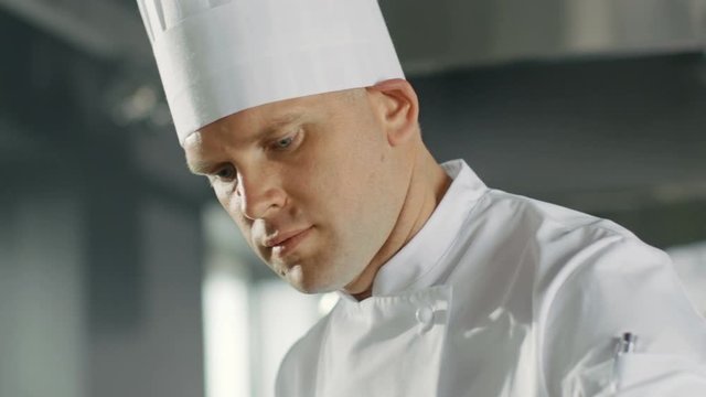 Close-up of a Famous Chef Concentrated on Cooking Perfect Dish. Shot on RED EPIC-W 8K Helium Cinema Camera.