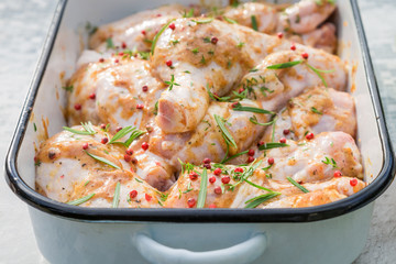Closeup of chicken legs with herbs and honey for grill