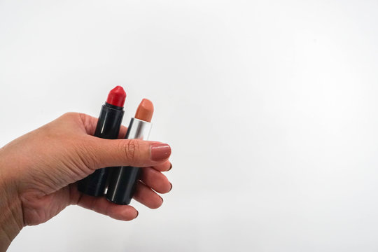 Isolated Women Hold Matte Red And Peach Orange Lipstick In Hand For Beauty