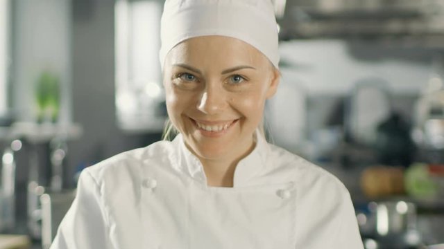 Portrait of a Young Woman Chef Smiling While Cooking in a Modern Kitchen. Shot on RED EPIC-W 8K Helium Cinema Camera.