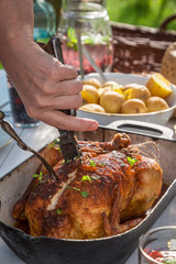 Closeup of cutting chicken on white table in the countryside