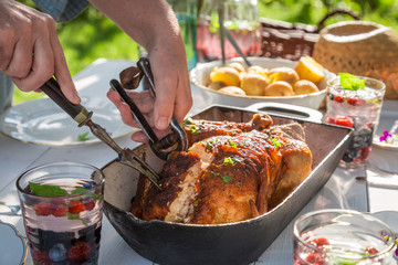 Dinner with potatoes and chicken served in the summer garden