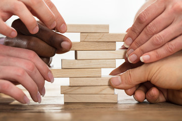 Businesspeople Stacking Wooden Blocks