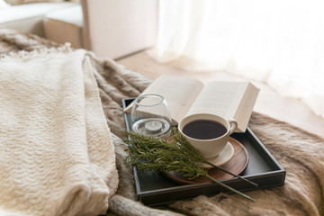 Coffee and book on the bed with window light in the morning 