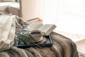 Coffee and book on the bed with window light in the morning 