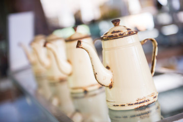 Old rusty kettles yellow