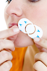 Model Invisible patch used in the treatment of labial herpes It covers the fever blister which does...