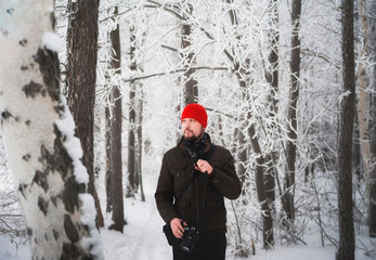 Fototapeta na wymiar Beautiful winter snow-covered forest, Saratov, Russia. Firs, birches in the snow, branches of trees and frost. tourists in the winter in the woods