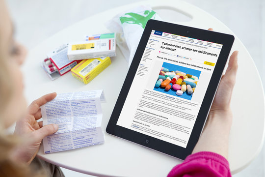 Woman reading an article about buying medicines online